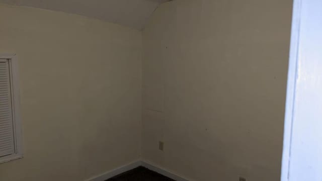 empty room featuring vaulted ceiling