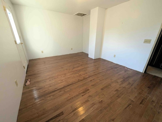 spare room featuring dark hardwood / wood-style floors