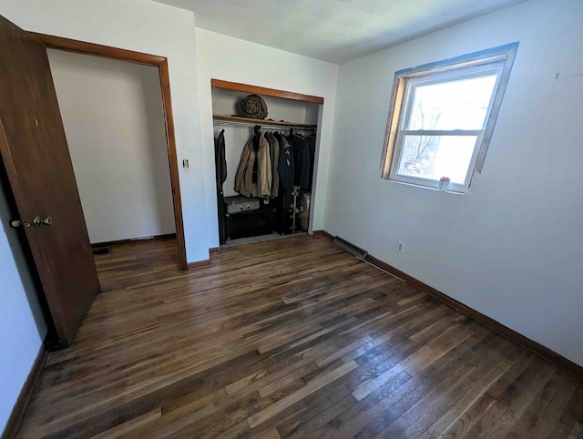 unfurnished bedroom featuring dark hardwood / wood-style floors and a closet