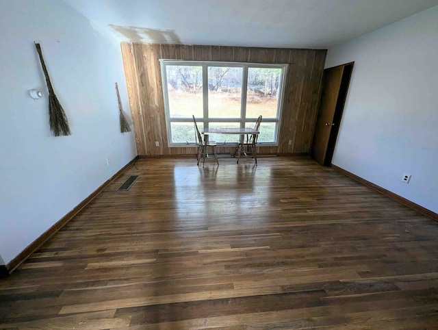 unfurnished room with dark hardwood / wood-style flooring