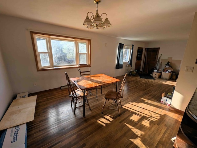 dining room featuring an inviting chandelier and dark wood-type flooring