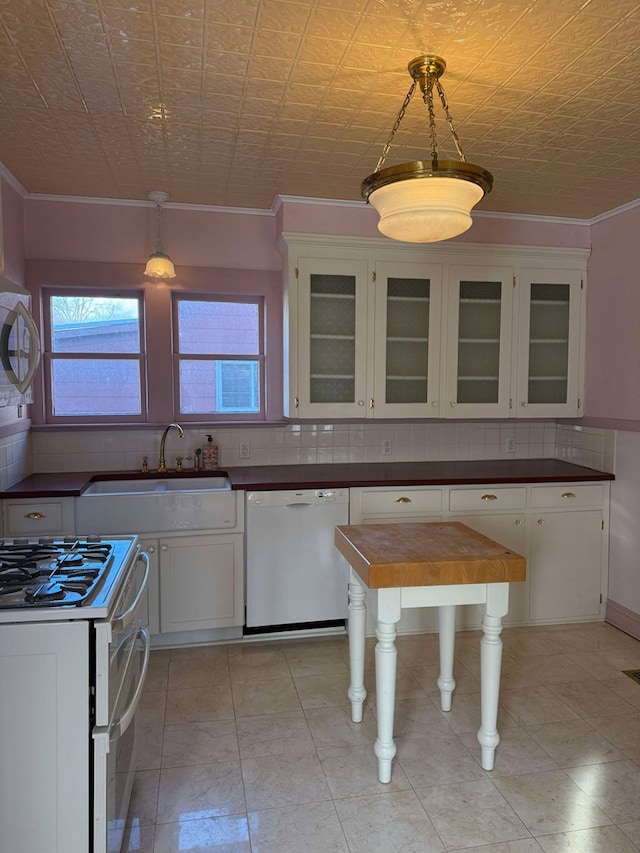 kitchen with white cabinets, pendant lighting, white appliances, and sink