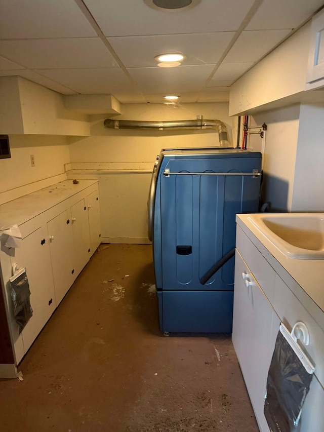 clothes washing area featuring washer / clothes dryer and cabinets