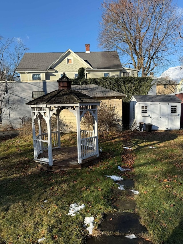 view of yard featuring a gazebo and a storage shed