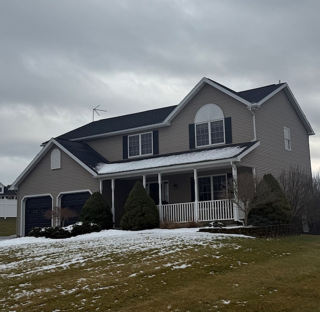 view of front of home featuring a porch and a garage