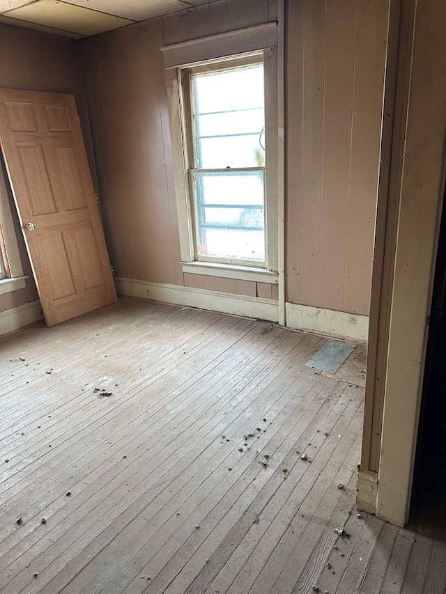 unfurnished room featuring light wood-type flooring and baseboards