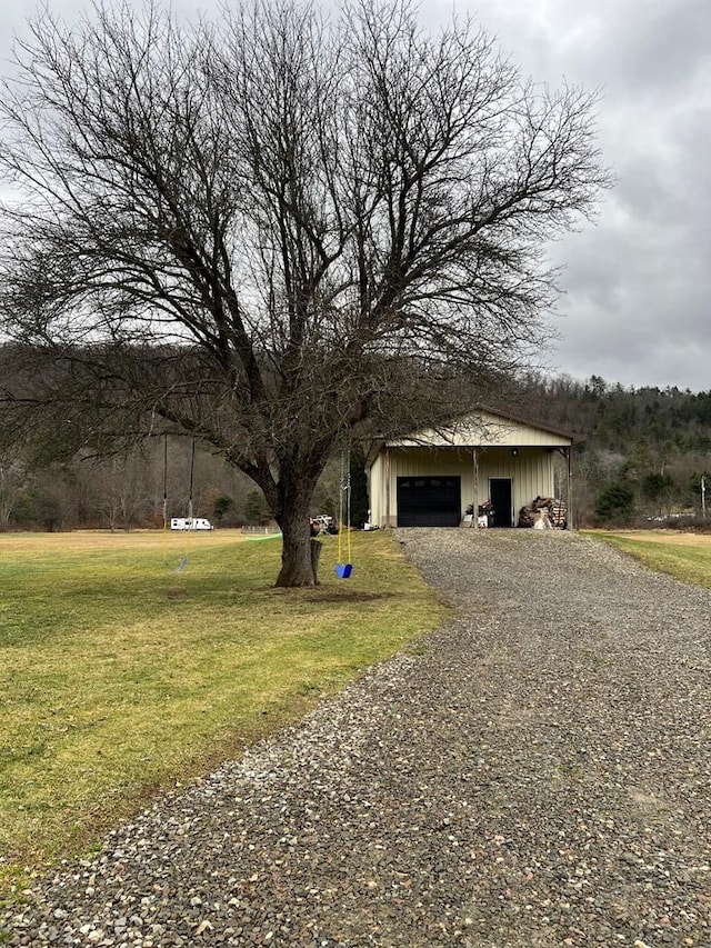 exterior space featuring a garage and a lawn