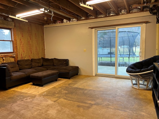 living room featuring plenty of natural light and concrete floors