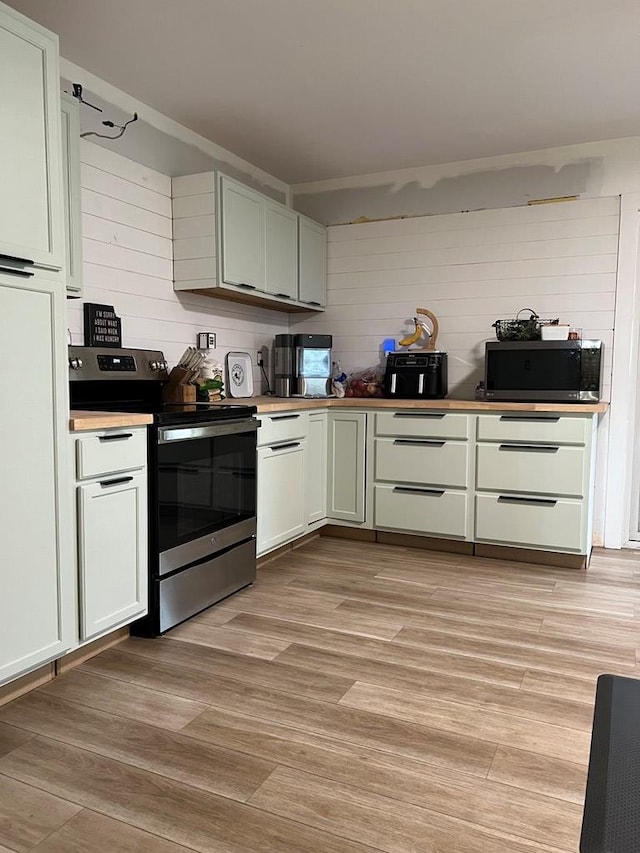 kitchen featuring light wood-type flooring and appliances with stainless steel finishes