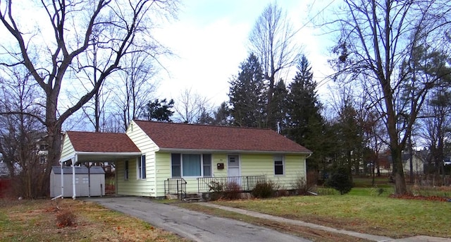 single story home with a front lawn and a carport