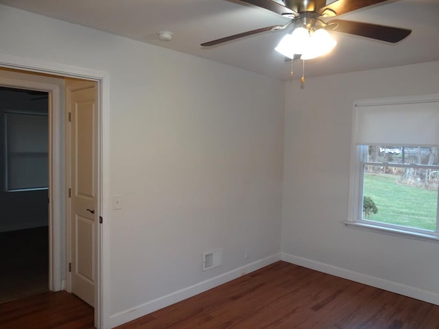 empty room featuring ceiling fan and dark hardwood / wood-style floors