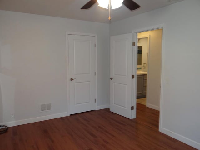 unfurnished bedroom featuring ceiling fan and dark hardwood / wood-style flooring