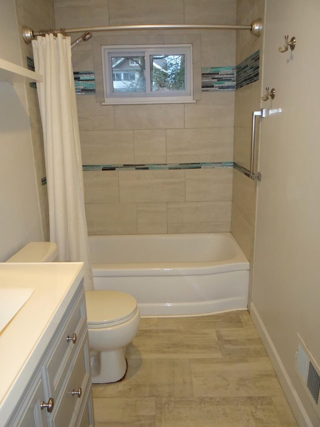 full bathroom featuring shower / bath combo with shower curtain, vanity, and toilet