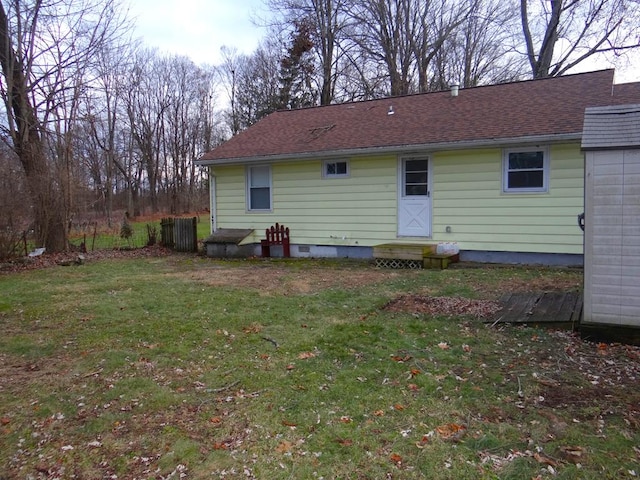 rear view of property with a lawn