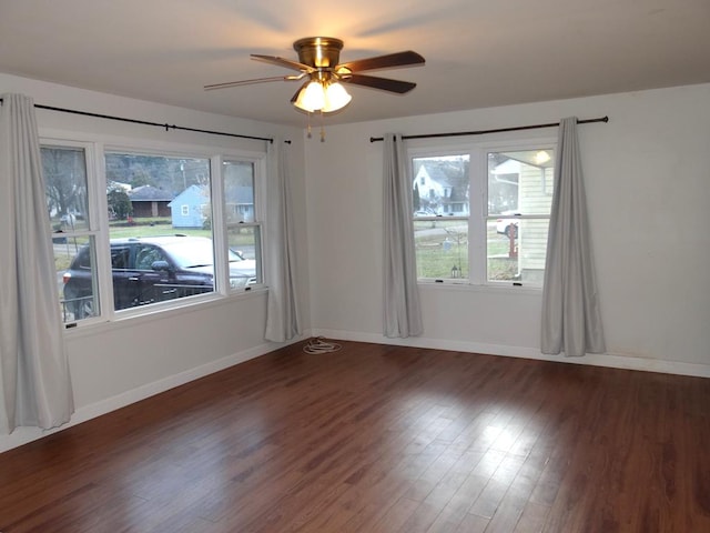 spare room with ceiling fan and dark wood-type flooring