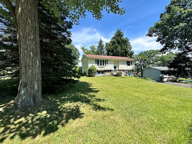 raised ranch with a front yard