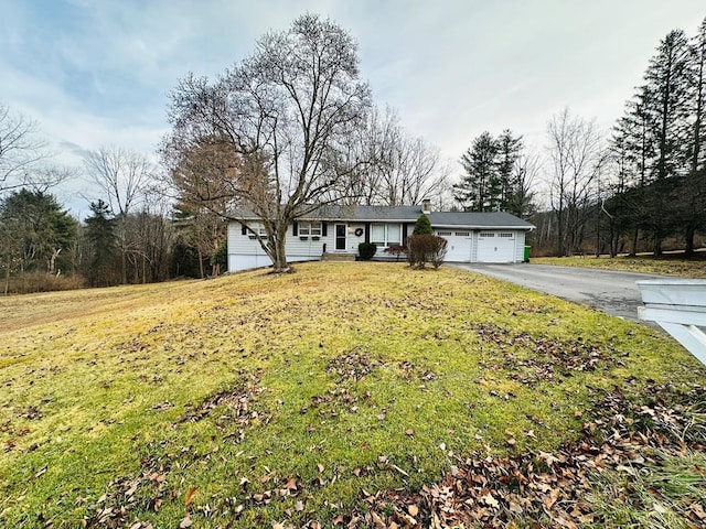 ranch-style house featuring a front lawn and a garage