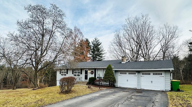 single story home with a front yard and a garage