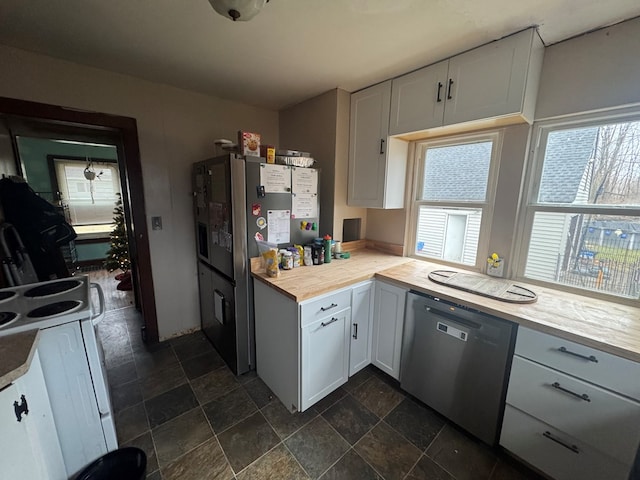 kitchen featuring dishwasher, white range with electric cooktop, white cabinetry, and wood counters