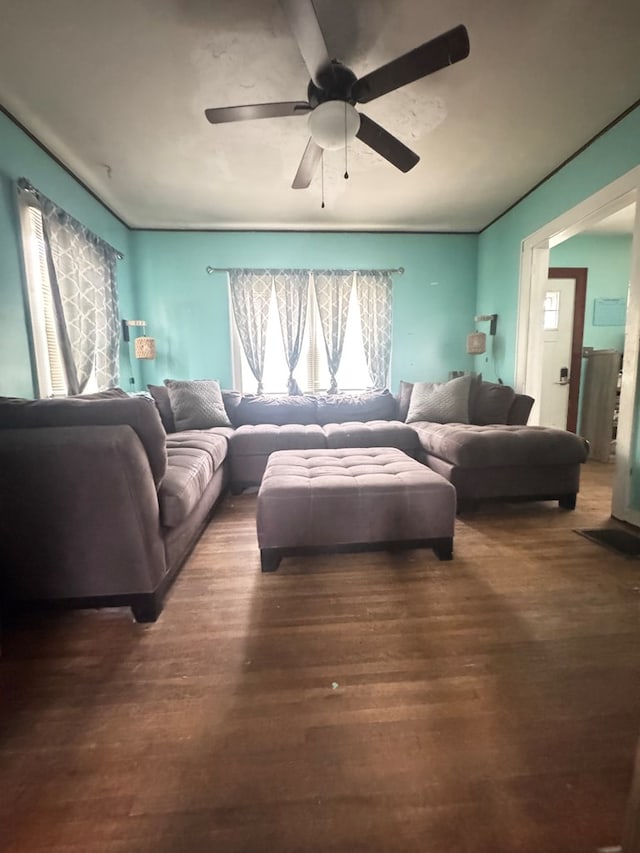 living room featuring a wealth of natural light, ceiling fan, and dark hardwood / wood-style floors