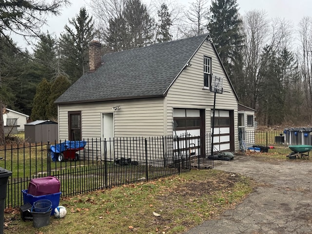 view of outdoor structure featuring a lawn and a garage