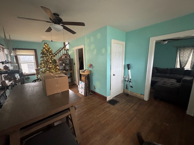 dining space with ceiling fan and dark hardwood / wood-style floors