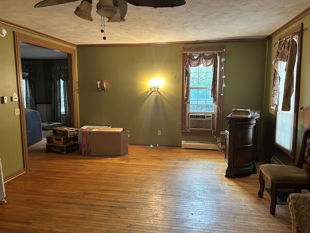 interior space with a baseboard radiator, crown molding, hardwood / wood-style floors, cooling unit, and a textured ceiling