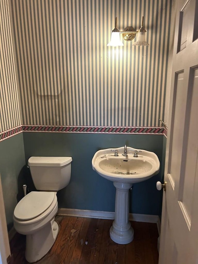 bathroom with toilet and hardwood / wood-style floors