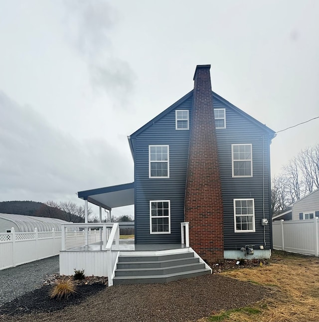 back of house with a wooden deck