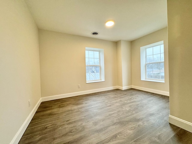 unfurnished room featuring dark hardwood / wood-style floors