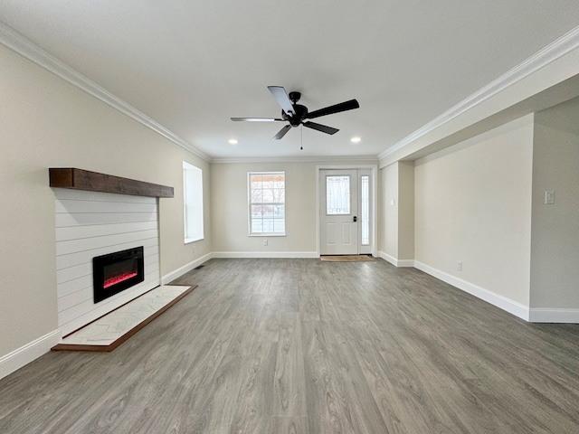 unfurnished living room with hardwood / wood-style flooring, crown molding, and ceiling fan