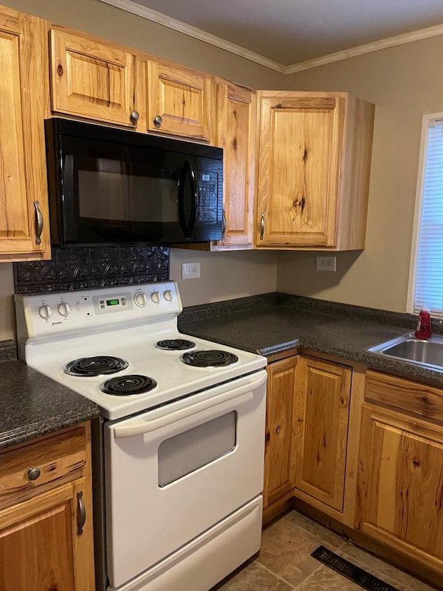 kitchen featuring white range with electric cooktop, sink, ornamental molding, and tile patterned floors