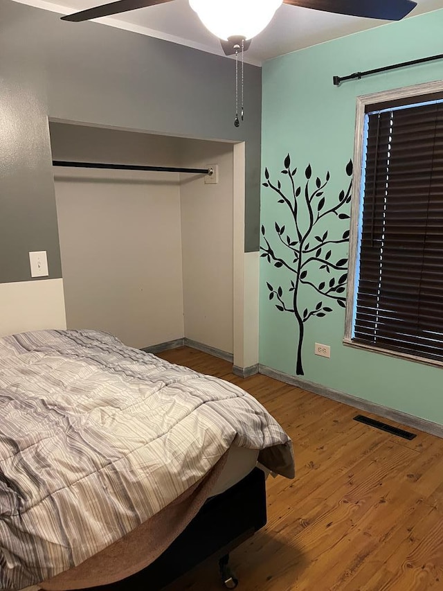 bedroom featuring hardwood / wood-style flooring and ceiling fan