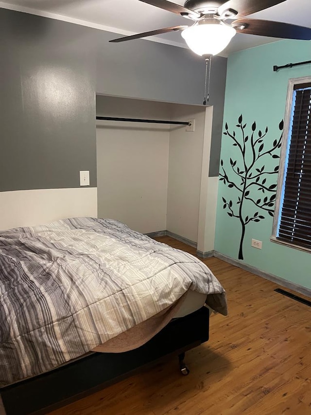 bedroom featuring ceiling fan and hardwood / wood-style flooring