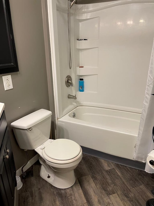 full bathroom featuring vanity, toilet, wood-type flooring, and shower / tub combo