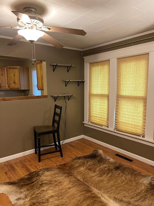 interior space featuring hardwood / wood-style floors and ornamental molding