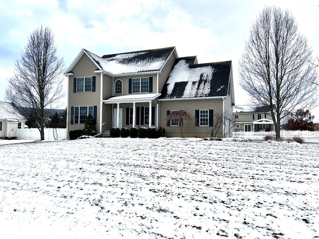 view of snow covered back of property