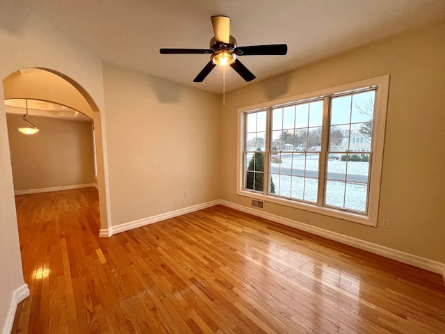 unfurnished room with ceiling fan and light hardwood / wood-style flooring