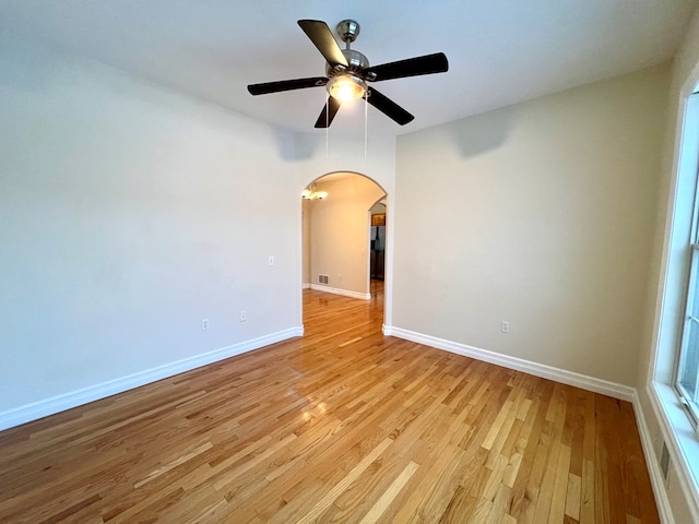 empty room with light hardwood / wood-style flooring and ceiling fan