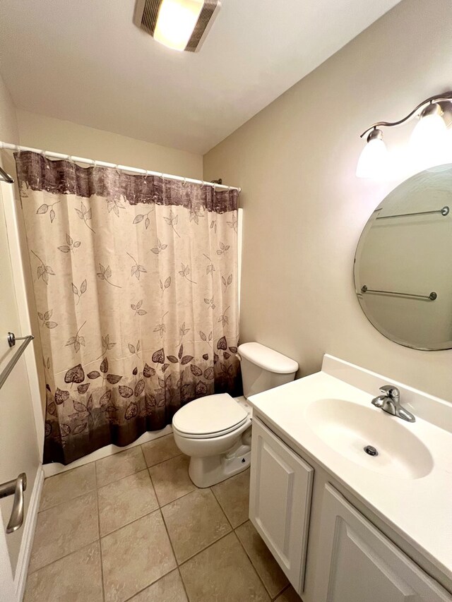 bathroom with vanity, a shower with curtain, tile patterned floors, and toilet