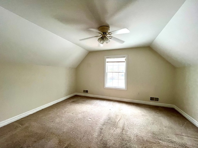 additional living space featuring carpet floors, vaulted ceiling, and ceiling fan