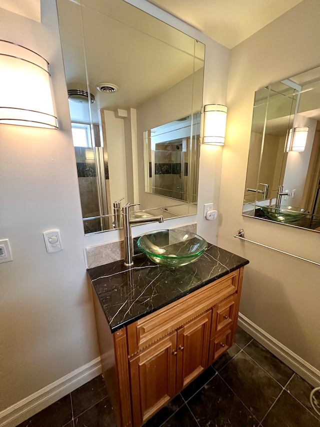 bathroom with tile patterned floors and vanity