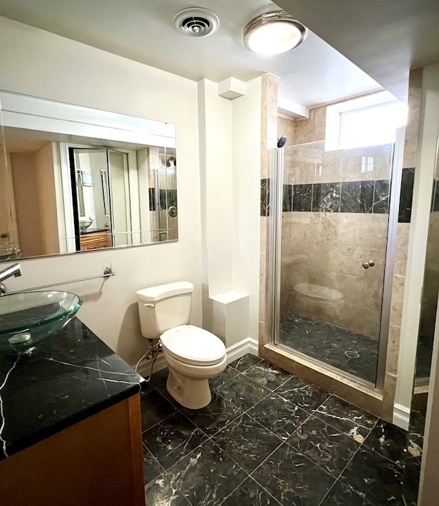 bathroom with walk in shower, vanity, and toilet