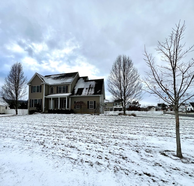 view of snow covered rear of property