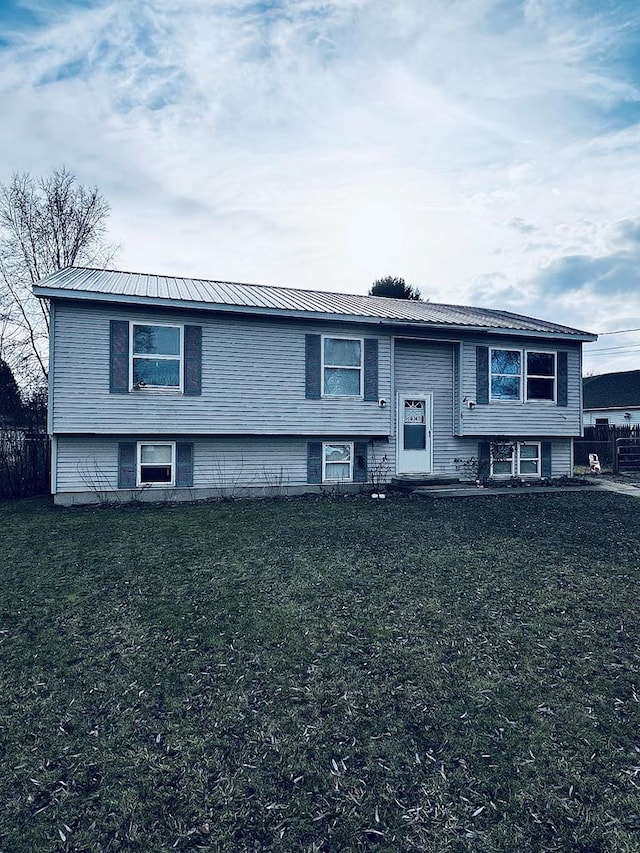 split foyer home with a front lawn