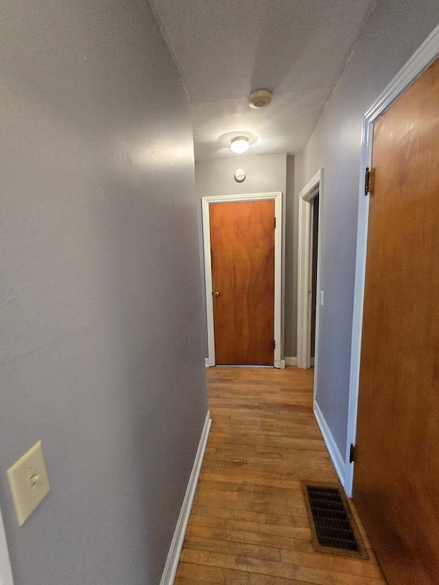 hallway with light wood-type flooring