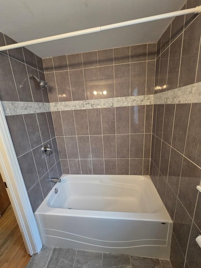 bathroom with tile patterned flooring and tiled shower / bath combo