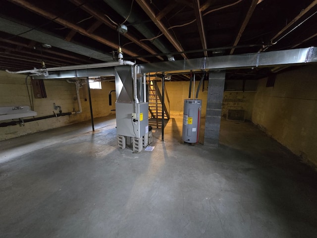 basement with electric water heater and heating unit