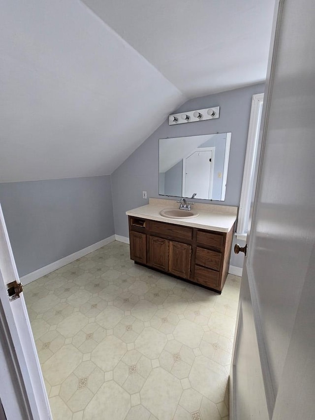 bathroom with vanity and vaulted ceiling