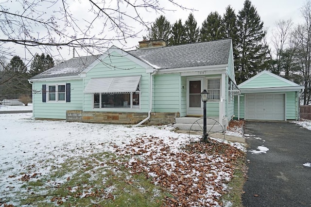 view of front of property featuring an outdoor structure and a garage